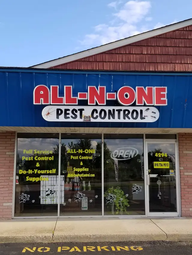 The All-N-One Pest Control storefront at 4294 Richfield Road, red lettering on a navy sign, the door marked open